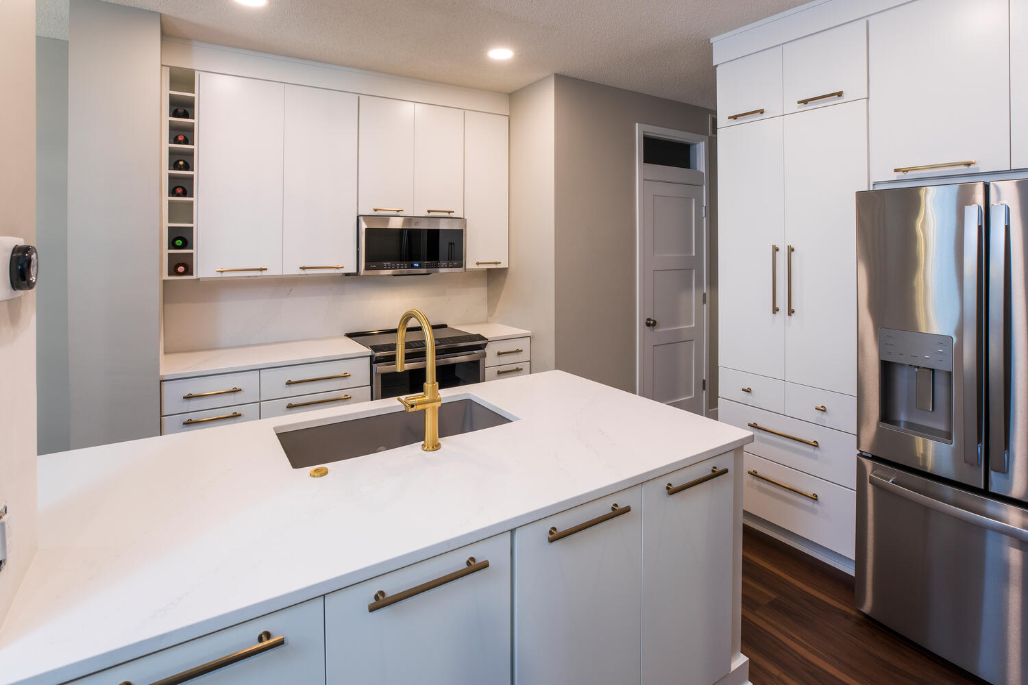 Modern Kitchen with White Cabinets and White Countertops from The Cabinet Store and Culina Design.